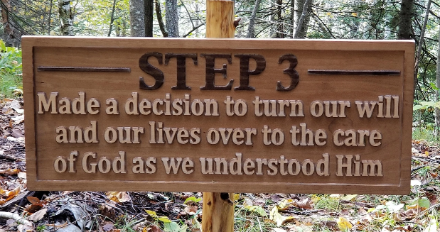 a carved wooden sign that says " Step 3: Made a decision to turn our will and our lives over to the care of God as we understood Him."