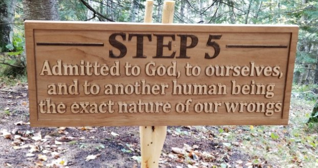 a carved wooden sign that says "Step 5: Admitted to God, to ourselves, and to another human being the exact nature of our wrongs."