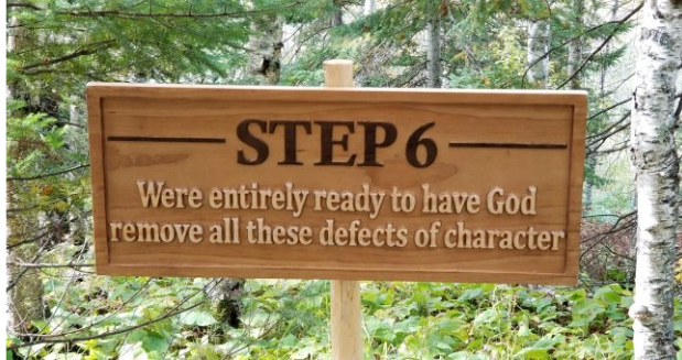 a carved wooden sign that says "Step 6: Were entirely ready to have God remove all these defects of character."