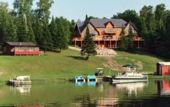 view from the lake of the shore with docks and boats.