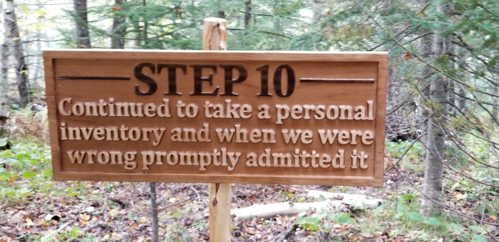 a carved wooden sign that says "Step 10: Continued to take a personal inventory and when we were wrong promptly admitted it."