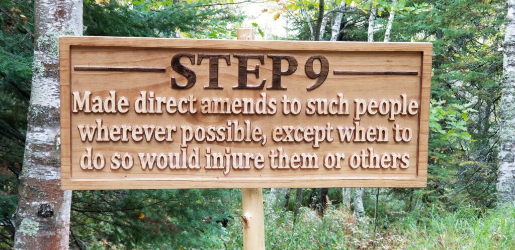 a carved wooden sign that says "Step 9: Made direct amends to such people wherever possible, except when to do so would injure them or others."