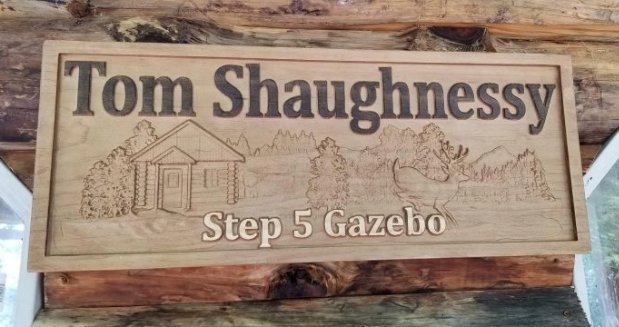a carved wooden sign that says "Tom Shaughnessy. Step 5 Gazebo"